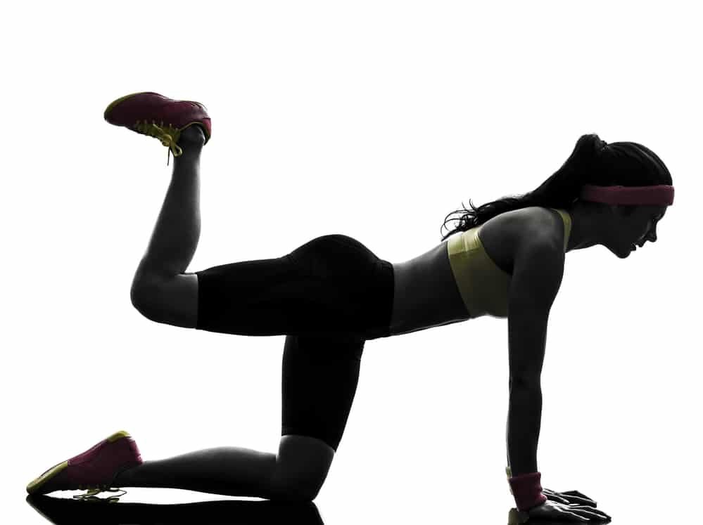 woman exercising fitness workout plank position silhouette fat burn